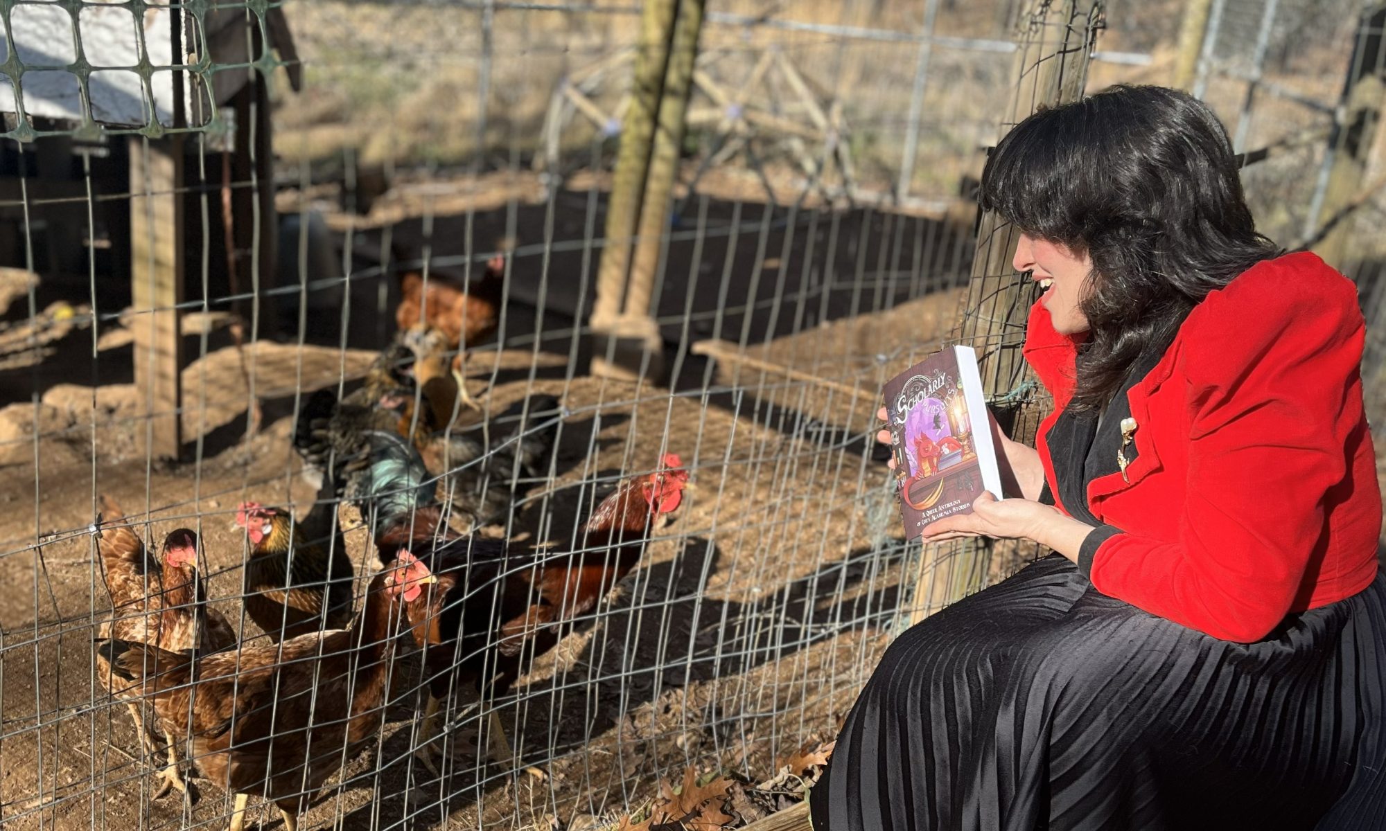 Lucy K.R. displays a copy of Scholarly Pursuits to a seemingly interested flock of chickens.