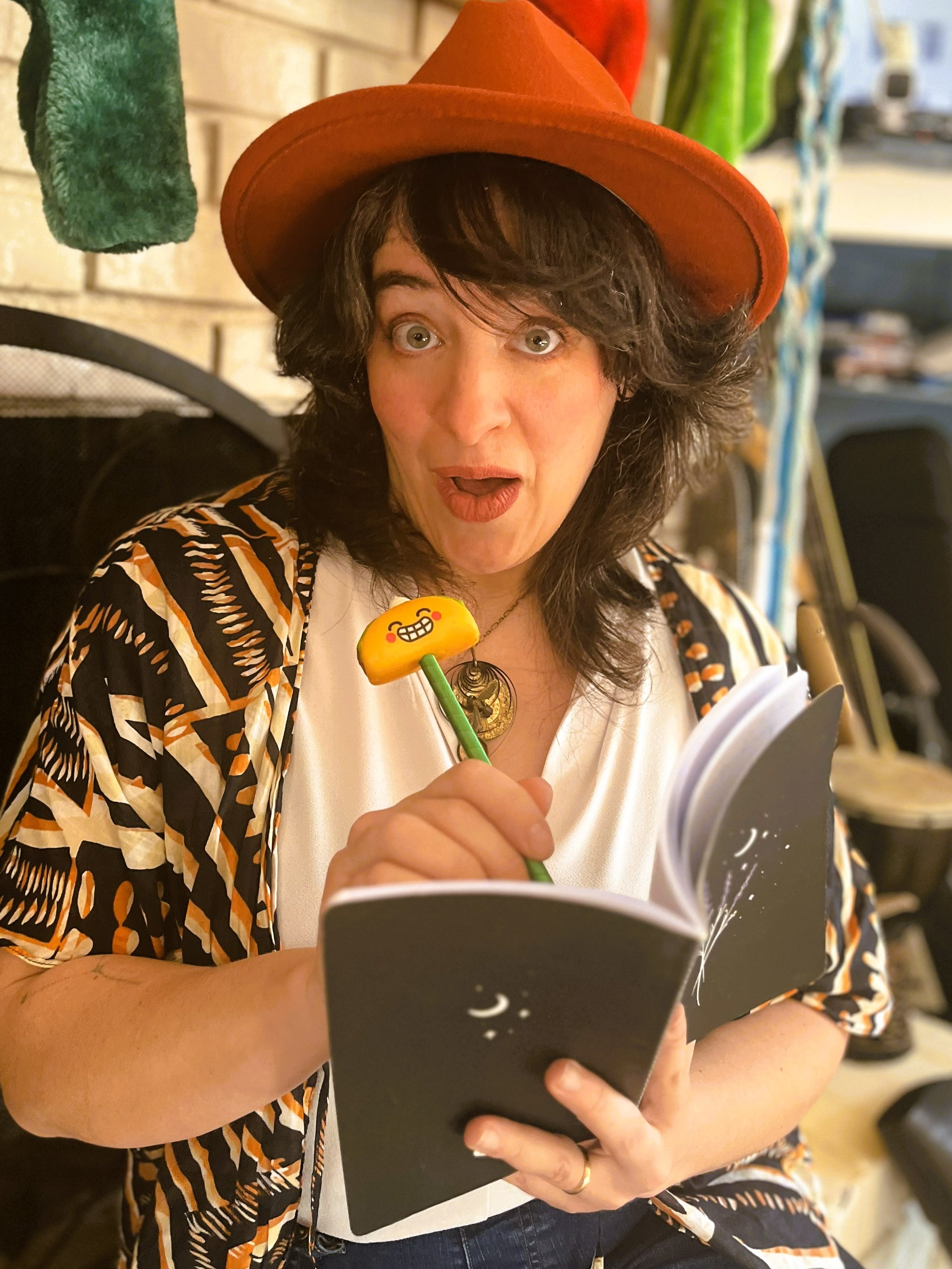 Follow up image: Lucy K.R. pretends to be startled that the camera has captured her writing.